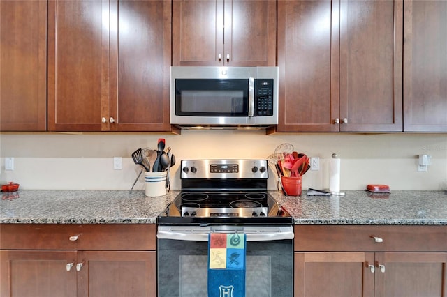 kitchen featuring light stone countertops and appliances with stainless steel finishes