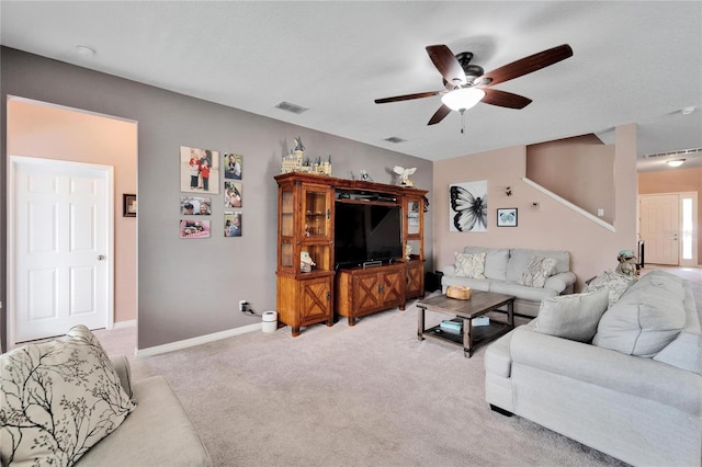 carpeted living room featuring ceiling fan