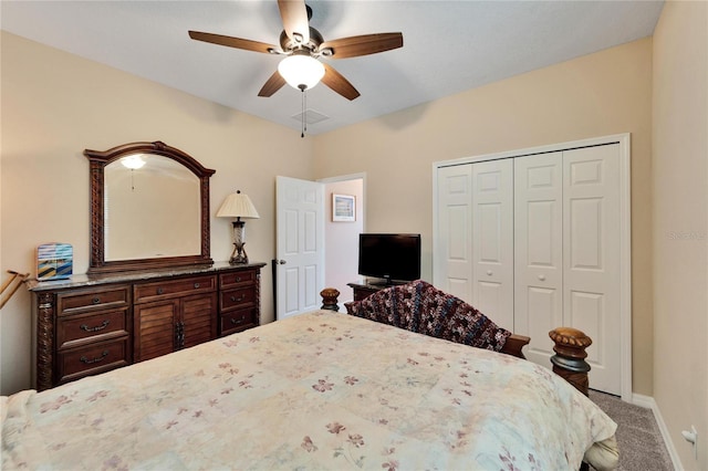 carpeted bedroom featuring a closet and ceiling fan