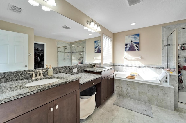 bathroom with vanity and separate shower and tub