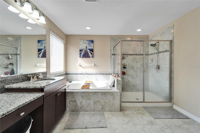 bathroom with vanity and separate shower and tub