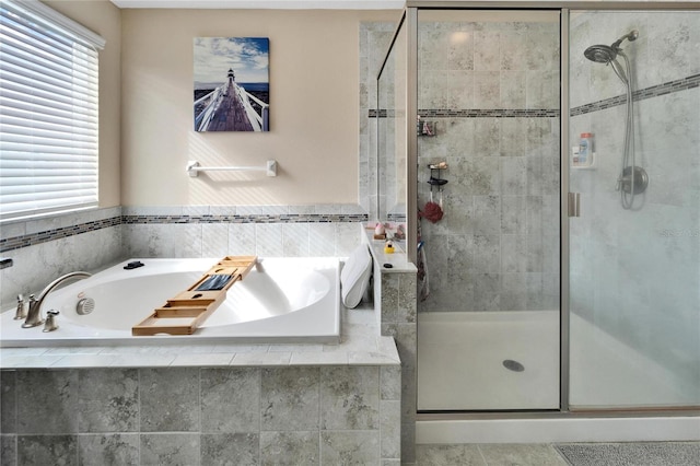 bathroom with separate shower and tub and a wealth of natural light