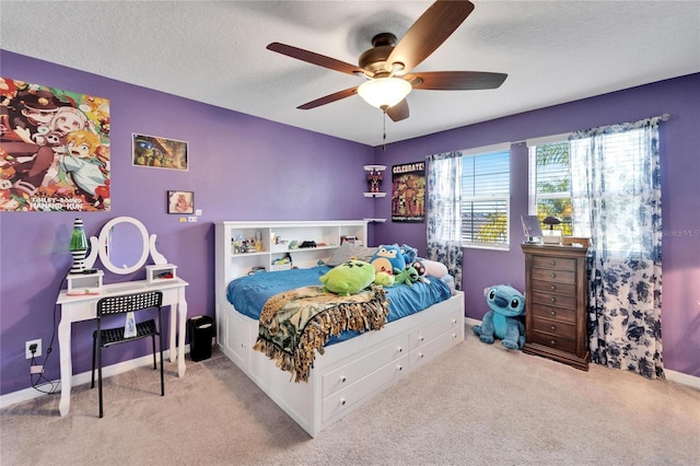 carpeted bedroom with ceiling fan and a textured ceiling