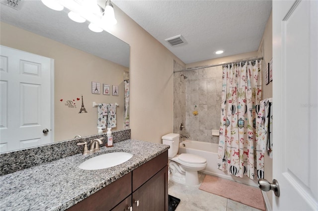 full bathroom featuring shower / bath combination with curtain, vanity, a textured ceiling, tile patterned flooring, and toilet