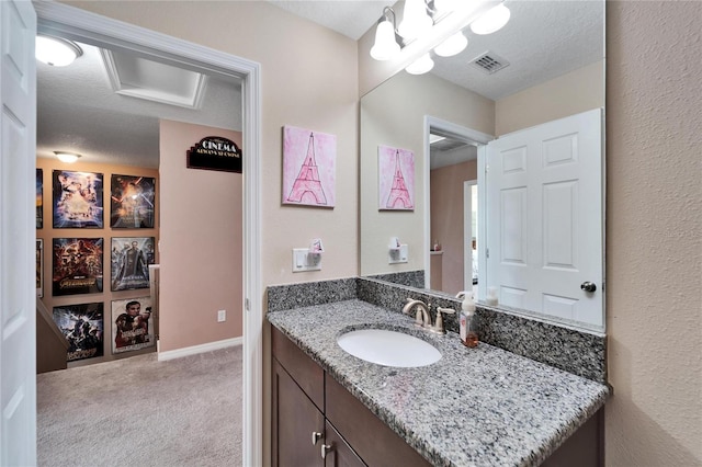 bathroom with vanity and a textured ceiling