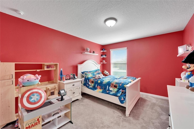 bedroom with a textured ceiling and light colored carpet