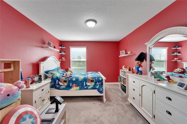 carpeted bedroom featuring a textured ceiling and multiple windows