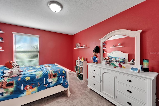 bedroom with light carpet and a textured ceiling