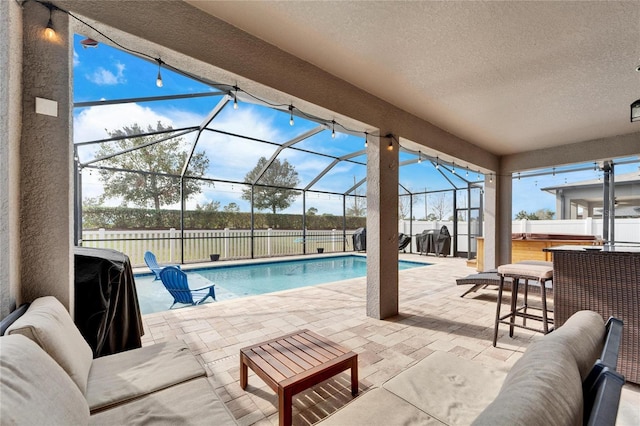 view of swimming pool with glass enclosure, a jacuzzi, a patio, and an outdoor hangout area