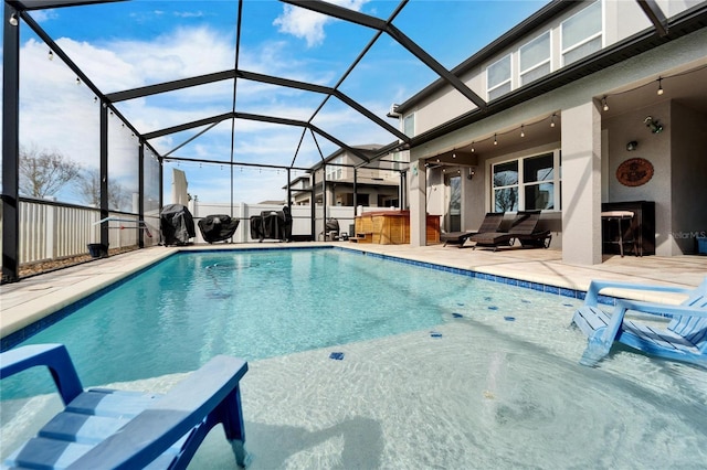 view of swimming pool with a bar, a patio, ceiling fan, and a lanai