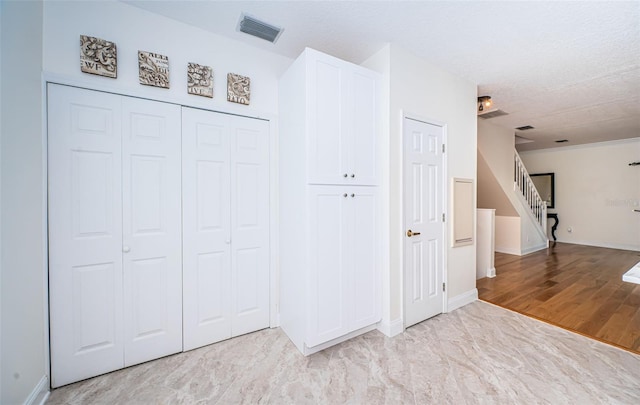 interior space featuring a textured ceiling and light wood-type flooring