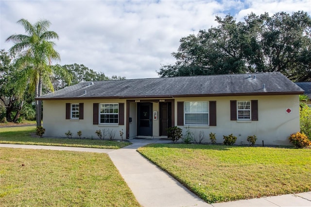 ranch-style home with a front lawn