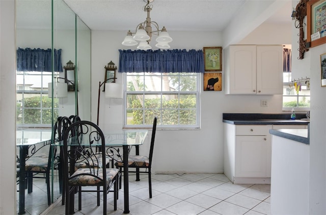 4215 E Bay Dr Unit 104, Clearwater, FL 33764 - dining area featuring a chandelier and light tile patterned floors