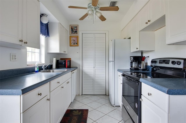 4215 E Bay Dr Unit 104, Clearwater, FL 33764 - kitchen featuring stainless steel range with electric stovetop, a ceiling fan, white cabinets, and light tile patterned floors