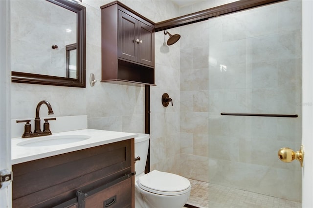 bathroom featuring walk in shower, vanity, toilet, and tile walls