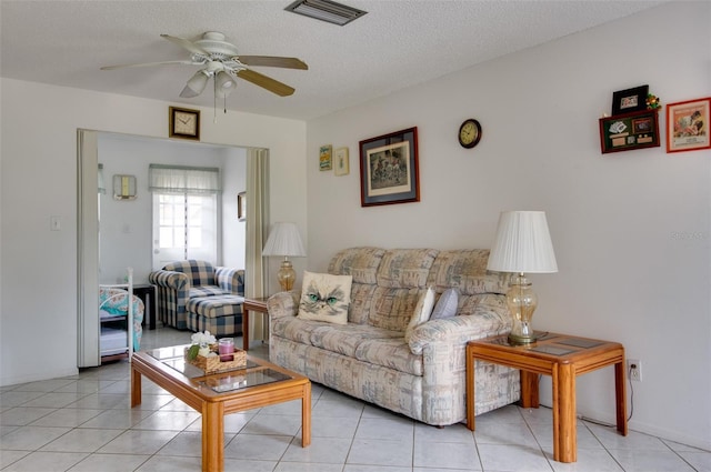 4215 E Bay Dr Unit 104, Clearwater, FL 33764 - living area with ceiling fan, a textured ceiling, and light tile patterned flooring