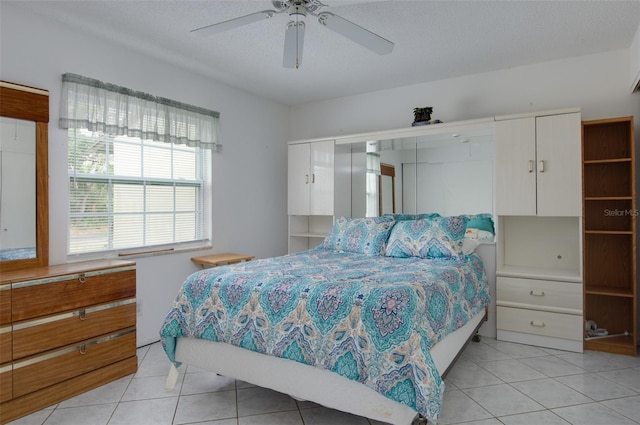 4215 E Bay Dr Unit 104, Clearwater, FL 33764 - bedroom featuring light tile patterned floors and a ceiling fan