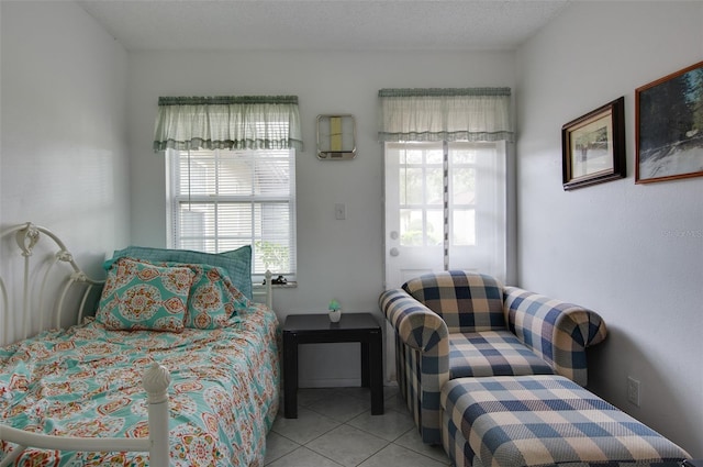 tiled bedroom featuring a textured ceiling