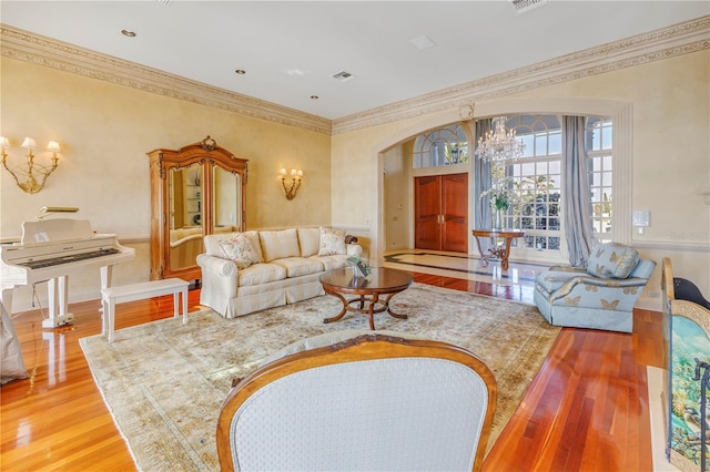 living room with hardwood / wood-style floors and an inviting chandelier