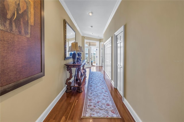 corridor with dark hardwood / wood-style flooring, french doors, and ornamental molding