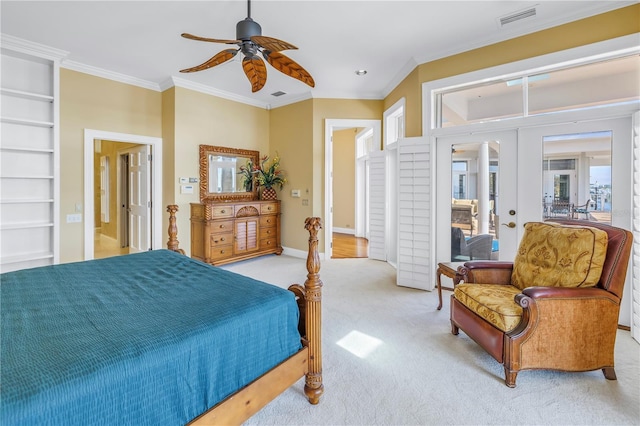 carpeted bedroom with ceiling fan, multiple windows, crown molding, and french doors