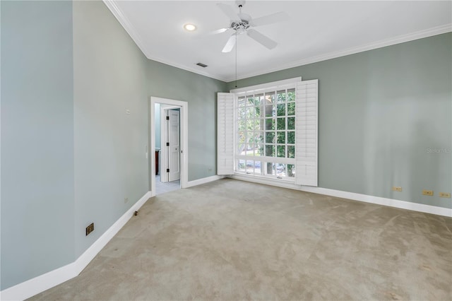 carpeted spare room featuring ceiling fan and ornamental molding