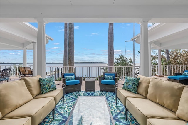 sunroom / solarium featuring a water view