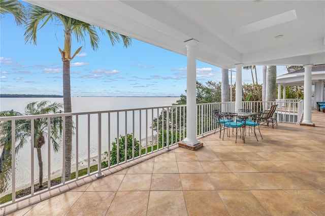 balcony featuring a beach view and a water view