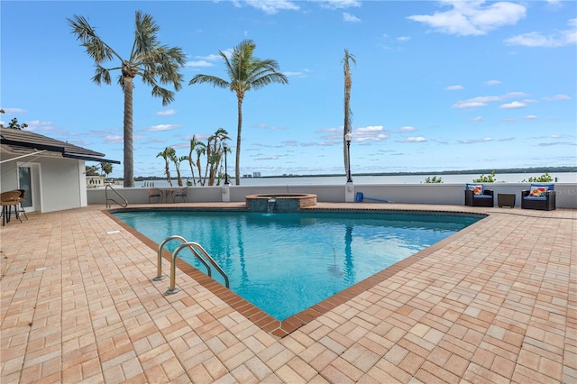 view of swimming pool featuring an in ground hot tub, a water view, and a patio