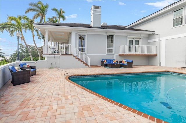 back of house with an outdoor hangout area and a patio