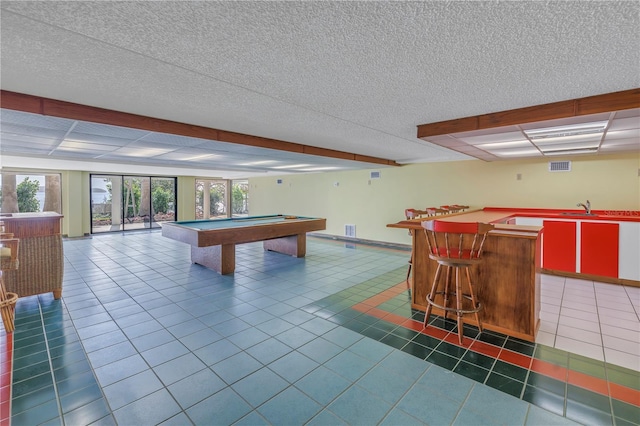 recreation room with wet bar, dark tile patterned floors, and billiards