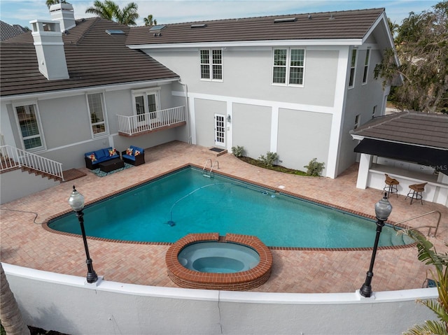 view of pool with an in ground hot tub, french doors, and a patio area