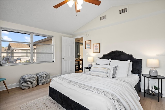 bedroom with lofted ceiling, ceiling fan, and light wood-type flooring