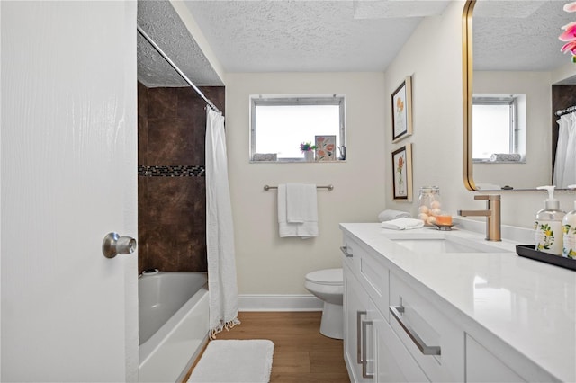 full bathroom with a textured ceiling, hardwood / wood-style flooring, and a wealth of natural light