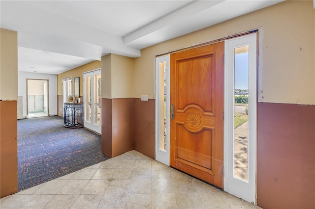 entrance foyer featuring light colored carpet