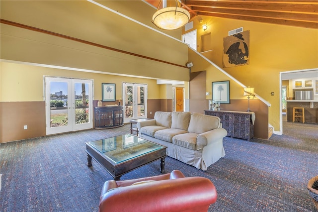 carpeted living room with french doors, high vaulted ceiling, and beam ceiling