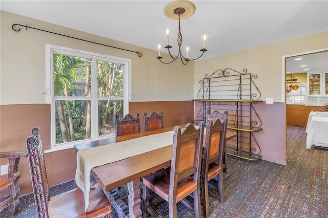 dining space with an inviting chandelier