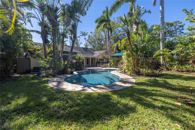 view of pool with a lawn