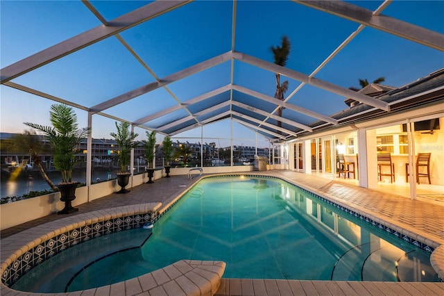 pool with glass enclosure and a patio