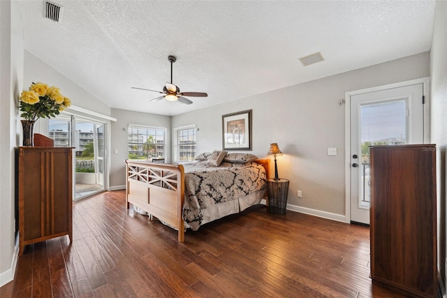 bedroom featuring a textured ceiling, baseboards, visible vents, access to outside, and dark wood-type flooring