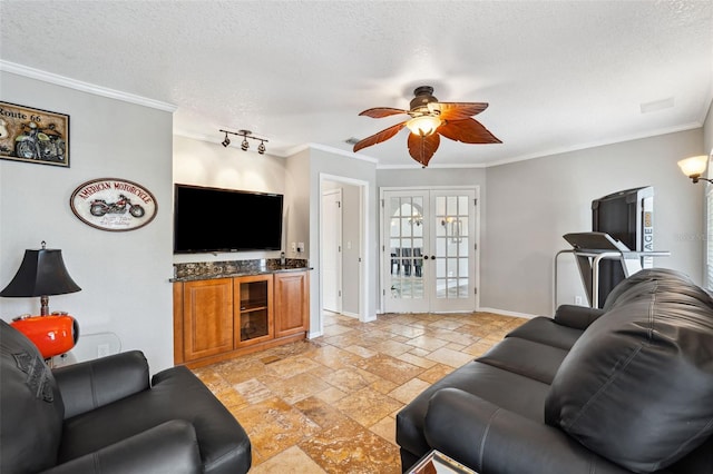 living room with ornamental molding, french doors, stone tile flooring, baseboards, and ceiling fan