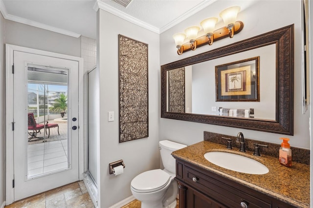 bathroom featuring stone finish floor, toilet, vanity, ornamental molding, and baseboards