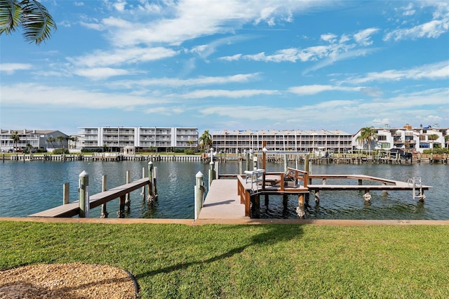view of dock with a lawn, boat lift, and a water view