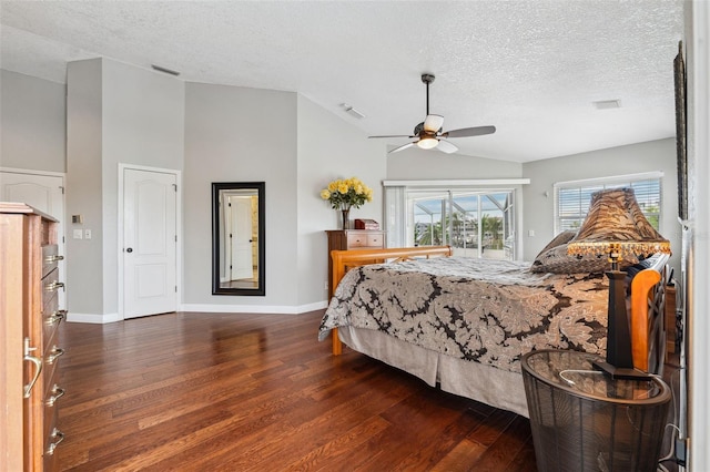 bedroom featuring lofted ceiling, a textured ceiling, and wood finished floors