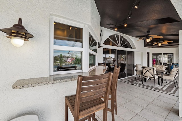 view of patio with ceiling fan and outdoor dining space