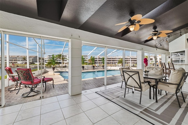 pool with a ceiling fan and a patio area