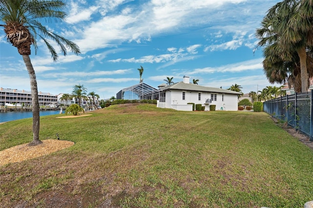 view of yard featuring a water view and fence