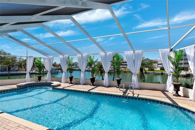 outdoor pool with a patio area, a lanai, and a water view