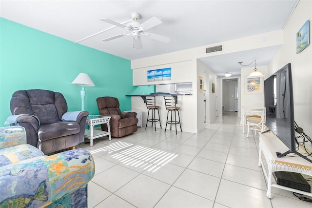 tiled living room with ceiling fan