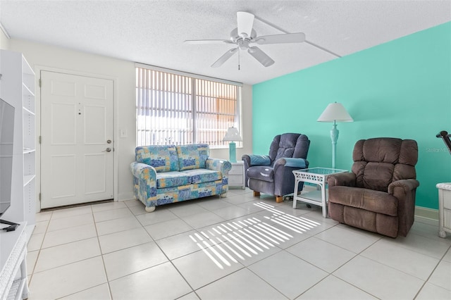 tiled living room with ceiling fan and a textured ceiling